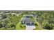 A high angle shot shows a well-situated home surrounded by verdant trees and lush foliage at 9262 Genesee St, Port Charlotte, FL 33981
