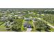 A bird's eye view reveals a home nestled within a leafy neighborhood at 9262 Genesee St, Port Charlotte, FL 33981