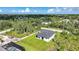 Aerial view of a secluded property surrounded by mature trees, lush foliage, and verdant greenery at 9262 Genesee St, Port Charlotte, FL 33981