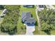 An aerial view shows the property's house on a large lot with lush green grass and surrounding foliage at 9262 Genesee St, Port Charlotte, FL 33981