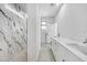 Modern bathroom design with double sinks and shower with marble accent wall at 9262 Genesee St, Port Charlotte, FL 33981