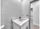 This bathroom features a modern vanity with a white countertop and dark hardware accents at 9262 Genesee St, Port Charlotte, FL 33981