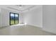Bright and airy bedroom showcases a sliding glass door with a view of the backyard at 9262 Genesee St, Port Charlotte, FL 33981