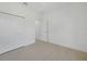 An empty bedroom with light tile flooring, a ceiling fan, and a closet with full-sized double doors at 9262 Genesee St, Port Charlotte, FL 33981