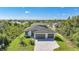 New construction home with paved driveway, two-car garage, professional landscaping, and modern design at 9262 Genesee St, Port Charlotte, FL 33981