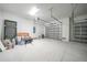 This spacious garage features concrete flooring, and a full-sized garage door at 9262 Genesee St, Port Charlotte, FL 33981