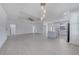 Spacious open layout with light tile flooring, modern lighting, and easy access to the kitchen at 9262 Genesee St, Port Charlotte, FL 33981