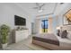 Comfortable main bedroom features a tray ceiling, neutral colors, decorative furnishing, and a sliding glass door at 9262 Genesee St, Port Charlotte, FL 33981