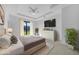 Comfortable main bedroom features a tray ceiling, neutral colors, decorative furnishing, and a sliding glass door at 9262 Genesee St, Port Charlotte, FL 33981