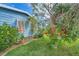 Landscaped yard with lush greenery adjacent to the home's side at 6432 Keena Ct, North Port, FL 34287