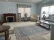 Spacious living room featuring a decorative rug and ample seating at 6432 Keena Ct, North Port, FL 34287