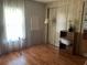 Bedroom with wood floors, large closet, and a small end table at 6432 Keena Ct, North Port, FL 34287