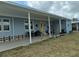 Covered patio area with seating and access to the home's entrance at 6432 Keena Ct, North Port, FL 34287