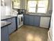 Updated kitchen with blue cabinets, granite counters, and tile backsplash at 6432 Keena Ct, North Port, FL 34287