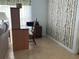 Home office with wood desk, chair, and birch tree wall covering at 6432 Keena Ct, North Port, FL 34287