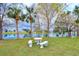 Peaceful pond-side seating area with benches and a table, overlooking a tranquil pond at 6432 Keena Ct, North Port, FL 34287