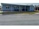 Front view of a light blue single wide manufactured home with covered carport at 6432 Keena Ct, North Port, FL 34287