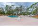Community pool with plenty of lounge chairs for relaxation at 6432 Keena Ct, North Port, FL 34287