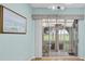 Screened porch with table and chairs, overlooking a golf course at 2024 Lynx Run, North Port, FL 34288