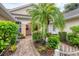 Inviting front patio with lush landscaping and brick walkway at 2024 Lynx Run, North Port, FL 34288