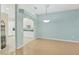 Bright dining room with wood floors and view of kitchen at 2024 Lynx Run, North Port, FL 34288