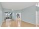 Light and airy living room with wood floors and access to a screened porch at 2024 Lynx Run, North Port, FL 34288