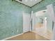 Bright bedroom with wood floors and view into another room at 2024 Lynx Run, North Port, FL 34288