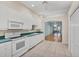 Kitchen features white cabinets, green countertops, and views to living room at 2024 Lynx Run, North Port, FL 34288