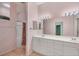 Double vanity bathroom with pink walls and a shower at 2024 Lynx Run, North Port, FL 34288