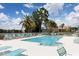 Community pool with plenty of lounge chairs at 2024 Lynx Run, North Port, FL 34288