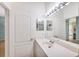 Bright bathroom with single sink vanity and large mirror at 2024 Lynx Run, North Port, FL 34288