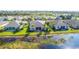 Aerial view of houses near a pond at 417 Tomoka Dr, Englewood, FL 34223