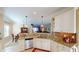 Kitchen with granite countertops, stainless steel appliances, and breakfast bar at 417 Tomoka Dr, Englewood, FL 34223