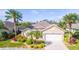 One-story house with two-car garage and landscaping at 417 Tomoka Dr, Englewood, FL 34223