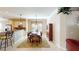 Open concept kitchen and dining area with granite countertops and stainless steel appliances at 417 Tomoka Dr, Englewood, FL 34223