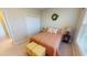 Bright bedroom with double bed, nightstand, and double door closet at 417 Tomoka Dr, Englewood, FL 34223