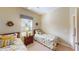 Bedroom with two twin beds, nightstand, and window at 417 Tomoka Dr, Englewood, FL 34223