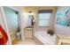 Bathroom with corner bathtub, double sinks and a separate toilet at 417 Tomoka Dr, Englewood, FL 34223