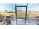 Screened patio with seating, grill, and pond view at 417 Tomoka Dr, Englewood, FL 34223
