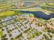 Aerial view of community amenities including pool, clubhouse, and golf course at 23516 Awabuki Dr # 5-201, Venice, FL 34293