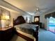 Main bedroom with private access to the pool and a ceiling fan at 2573 Chynn Ave, North Port, FL 34286