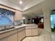 Open kitchen features a breakfast bar and views into the living area at 2573 Chynn Ave, North Port, FL 34286