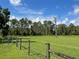 Fenced pasture area with lush green grass under a sunny sky at 2573 Chynn Ave, North Port, FL 34286
