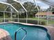 Inviting kidney-shaped pool with a screened enclosure at 2573 Chynn Ave, North Port, FL 34286