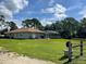 Home's back exterior showcasing a screened-in pool area at 2573 Chynn Ave, North Port, FL 34286