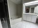Bathroom with corner bathtub, separate shower, and double sinks at 2573 Chynn Ave, North Port, FL 34286