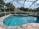 Refreshing kidney-shaped pool with screened enclosure at 2573 Chynn Ave, North Port, FL 34286