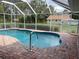 Relaxing kidney-shaped pool with a screened enclosure at 2573 Chynn Ave, North Port, FL 34286