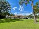 Single-story home with a large yard and mature trees at 2573 Chynn Ave, North Port, FL 34286