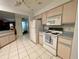 Kitchen with white appliances and ample cabinet space at 2573 Chynn Ave, North Port, FL 34286